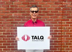 Simon Dunkley, Secretary General of the TALQ Consortium, shows the TALQ logo