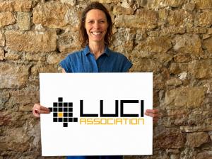 Jasmine van der Pol, General Director of the LUCI Association, showing the LUCI logo