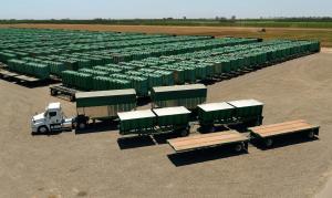 G3 Enterprises truck and agricultural harvest trailers at a California logistics yard surrounded by rows of green harvest bins.
