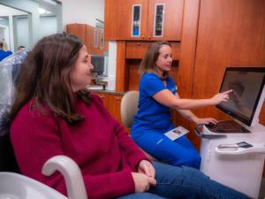 Dr. Alissa Roman reviewing a 3D digital intraoral scan with a patient during a restorative dentistry consultation at Roman Dental Arts in Hackensack, NJ
