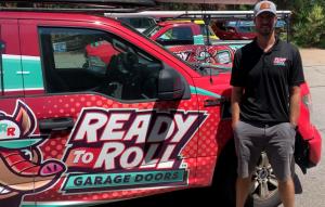 Ready To Roll Garage Doors technician standing beside a branded service truck serving Chapel Hill, Durham and Pittsboro homeowners.