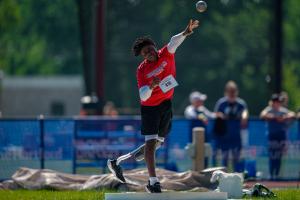 Black athlete with leg amputation throws shot put