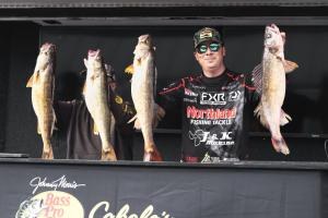 Tom Huynh holding four walleye, illustrating the expertise behind his TEDxFargo talk on structured fishing education.