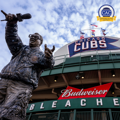 Wrigley Field exterior with statue and Chicago Cubs signage.