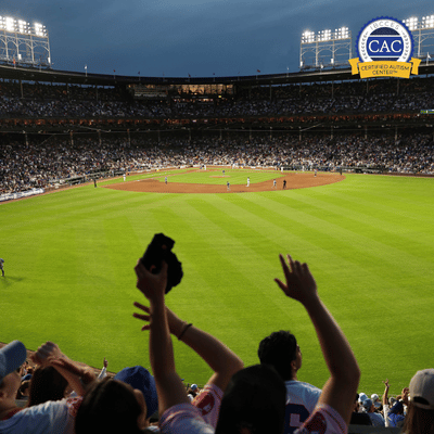 Crowd cheering at a baseball game in a large stadium with players on the field and a Certified Autism Center logo in the corner.