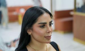 A specialist evaluates eyebrow hair direction and density during treatment planning.