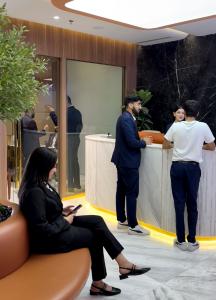 Reception and waiting area of a modern hair transplant clinic in Saudi Arabia with staff assisting patients.
