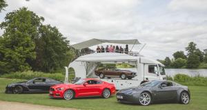 Hospitality Car Showcase ShowTruck mobile car showroom with cars displayed and guests hosted above | The Clear Idea