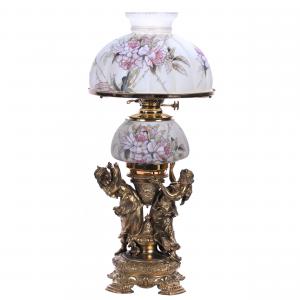 Circa 1880-1890 Mt. Washington banquet lamp titled Dancing Maidens, 26 ½ inches tall, having a three-dimensional gilded bronze base with full-figure maidens. Estimate: $3,000-$5,000