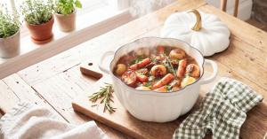Larder & Vine White Pumpkin Dutch Oven filled with hearty beef stew in a farmhouse kitchen.