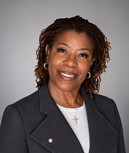 Headshot of Jocelyn Jones, Rising Tide Capital Board of Trustees member, smiling in a dark blazer.