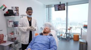 A male patient waits in a private and modern hair restoration clinic in Dubai.