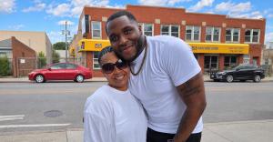Jennifer Maddox, Founder of Future Ties, poses with Chicago entertainer DLow at the Father’s Day Weekend Juneteenth Carnival and Free Food Giveaway in Chicago.