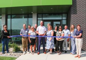 Members of the local Fargo Chamber of Commerce and Redpath team members celebrate ribbon cutting.