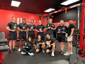Train With Dave coaching team at the Orange, California studio holding awards recognizing the company’s personal-training excellence across its Orange County locations.