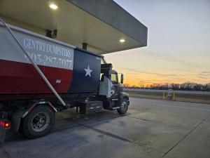 Gentry Dumpster Rentals delivery truck fueling up for roll-off dumpster deliveries in Grayson County TX.