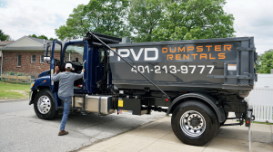 Jamaal Hazard, owner of PVD Dumpster Rentals, getting into his truck for a roll-off dumpster delivery in Cranston RI