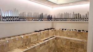 Japanese kitchen knives displayed on a wall inside MUSASHI JAPAN France White Store