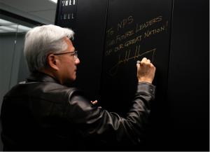 Jensen Huang, founder and CEO of NVIDIA, signs the exterior panel of the NVIDIA DGX GB300 AI supercomputer at the Naval Postgraduate School (NPS) in Monterey, California, July 22, 2026.