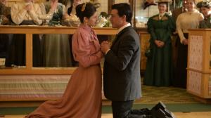 Finn Wittrock who plays Milton, and Alexandra Daddario who plays Kitty Hershey, are shown kneeling in the proposal scene from the movie, HERSHEY.