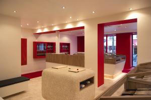 Interior of MUSASHI JAPAN France Red Store with red accents and wooden knife display cases.