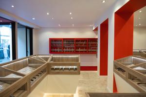 Interior of MUSASHI JAPAN France Red Store with red accents and wooden knife display cases.