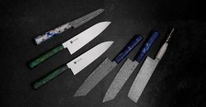 Assorted MUSASHI JAPAN Japanese kitchen knives displayed on a dark surface.
