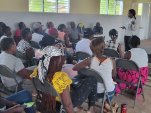 Group of Haitian women listening to an instructor traching business skills