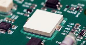 An electronic component is secured with Dymax 9310 reinforcement adhesive to a printed circuit board.