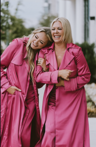 Mel Carr (left), founder of Six-Figure Chicks, embraces her sister, Sarah Riggs Vanderford, after the two reunited through AncestryDNA decades after Sarah was placed for adoption before Mel was born.