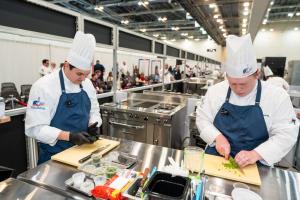 Two student chefs from SUNY Delhi chop vegetables in the ACF Student Team of the Year Competition