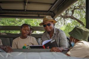 African Bush Camps CEO Beks Ndlovu with Little Ranger Program Participants