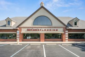 Storefront of McCool's Flooring, Carmel, IN with business name in red