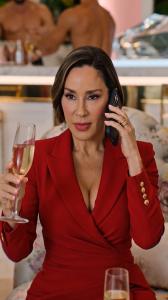 Jessica Hernandez Park, CEO of Park Ave Cosmetic Center, in a scene from the company's AI-powered episodic entertainment series, holding a champagne glass while speaking on the phone.