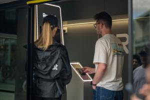 Nomad Luxe mobile pop up shop with a visitor signing up at the Revolut unit's LED-lit entrance | The Clear Idea