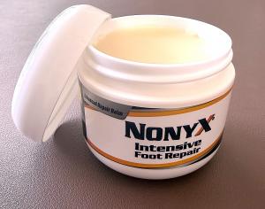 Open jar of NONYX Intensive Foot Repair showing balm and jar label