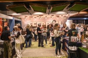 Attendees visit vendor booths and speak with pet wellness brands inside the Feed Real Summit Partner & Vendor Expo in San Diego.