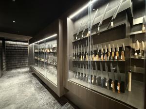 Japanese kitchen knives displayed in glass cases inside MUSASHI JAPAN Shibuya Center-Gai Store
