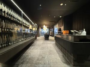 Modern retail space inside MUSASHI JAPAN Shibuya Center-Gai Store with glass knife displays and a customer counter