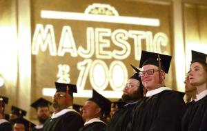 Graduates in caps and gowns sit onstage during the 2026 Master of Arts in American History commencement ceremony.