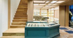 Interior of MUSASHI JAPAN Osaka Namba Ebisubashi Store with glass knife display counter and wooden staircase