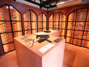 Interior of MUSASHI JAPAN Kanazawa Higashi Chaya Store with red-brown knife displays and Japanese kitchen knives