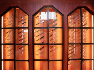 Japanese kitchen knives displayed in red-brown cases inspired by Kanazawa design at MUSASHI JAPAN Kanazawa Higashi Chaya Store