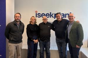 Five executives posing for a photo