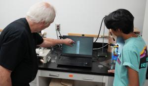 Doctor Samuel Prien and graduate student Sanjana Akula show an image on a computer screen.