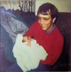 Doctor Samuel Prien holding an infant.
