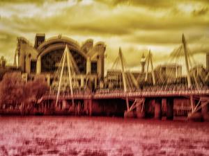 “Innocent City” by Antonina Minova, a duotone abstract ICM photograph of London’s South Bank in golden yellow and deep burgundy with softened architecture and flowing movement.