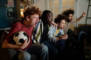 Friends watching the 2026 FIFA World Cup together at home, illustrating shared sports viewing.