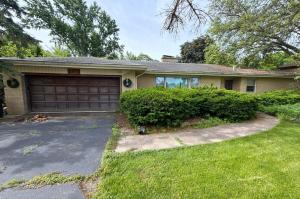 Exterior of an inherited single-story home in Downers Grove, Illinois, before its sale. The property required significant attention and was part of a complex estate situation involving deferred maintenance and other challenges.