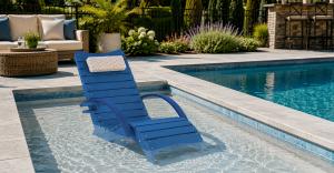 Blue AquaCurve upright in-pool lounge chair with armrests on a shallow tanning ledge in a backyard pool.